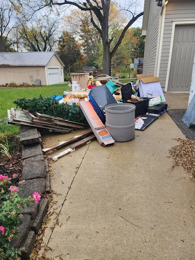 Dumpster being loaded with debris for Commercial Dumpster Rental in Raisinville
